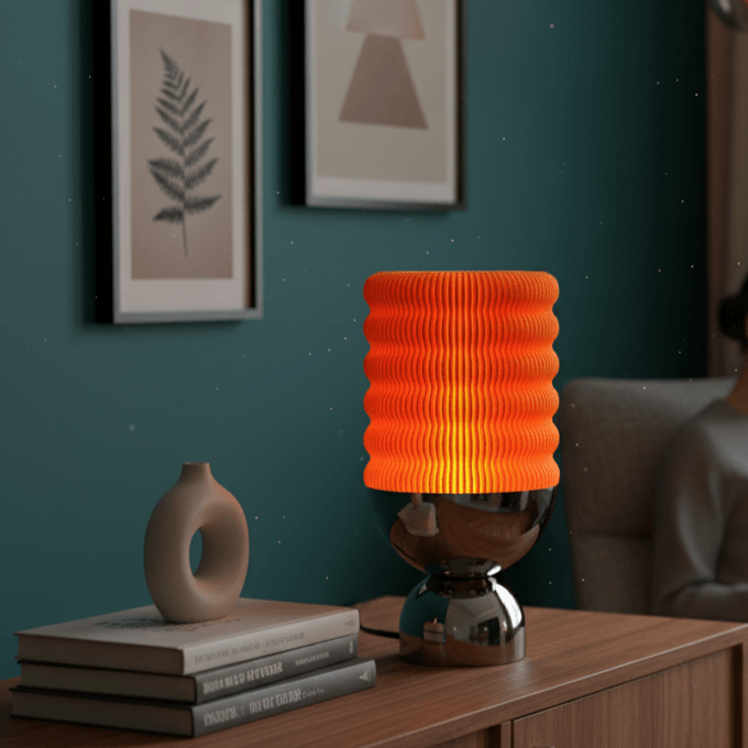 Orange textured lamp on a wooden side table with books and a decorative vase against a teal wall.