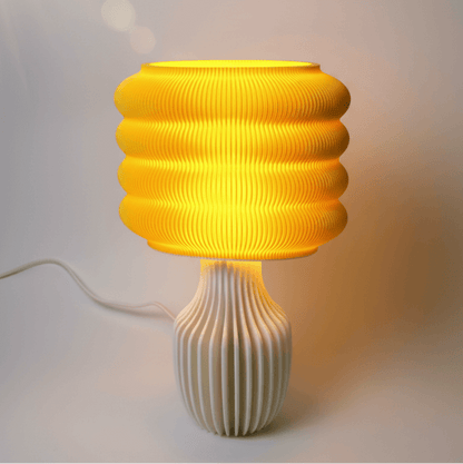 Yellow ribbed table lamp on a white background